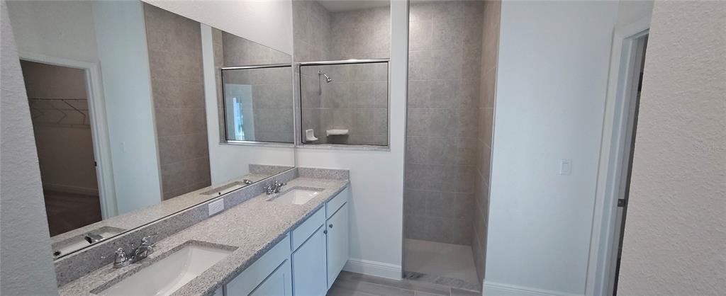 75 Kankakee Trail Palm Coast, FL 32164 - Photo 7 of 11 a bathroom with a granite countertop sink and a mirror