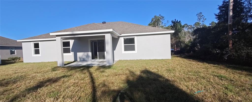 75 Kankakee Trail Palm Coast, FL 32164 - Photo 9 of 11 a front view of a house with a yard