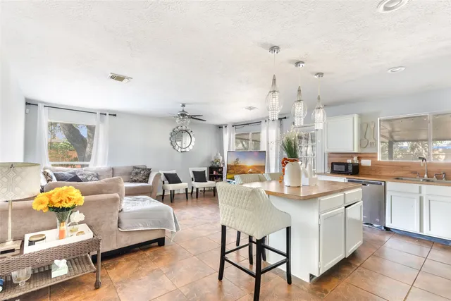 a very nice looking living room with stainless steel appliances