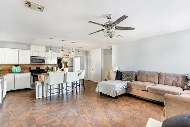 a living room with furniture and kitchen view