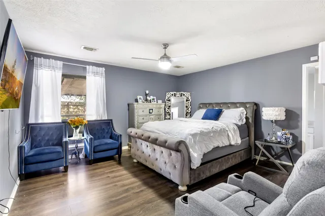 a bedroom with a bed couch and a window