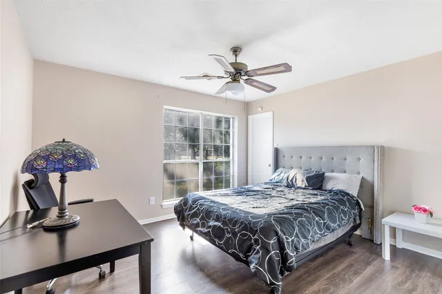 a bedroom with a bed window and a desk