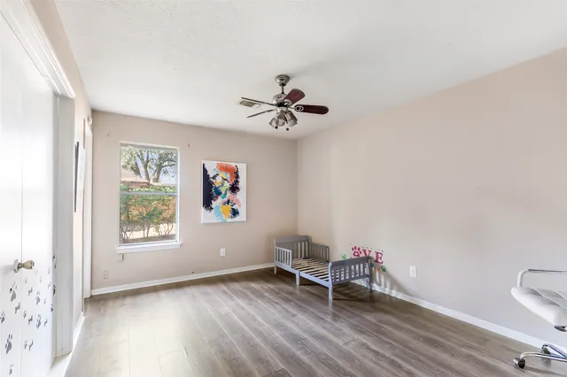 a view of workspace with wooden floor and a ceiling fan
