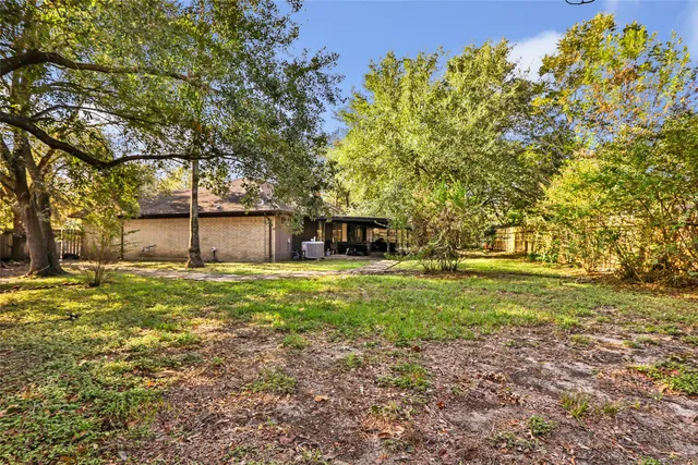 a backyard of a house with a table and chair