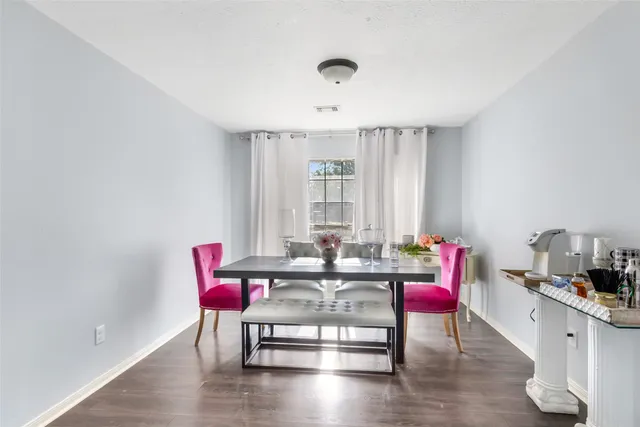 a dining room with furniture and wooden floor