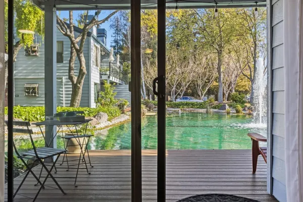 a view of a porch with chairs and backyard