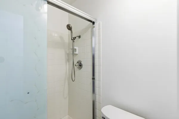 a bathroom with a toilet and a shower