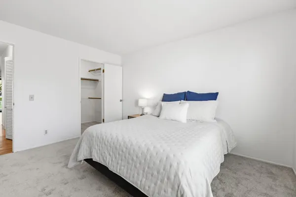 a bedroom with a bed and a night stand