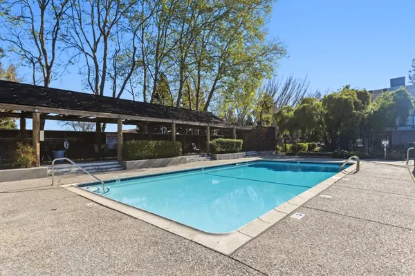a view of a swimming pool with a patio