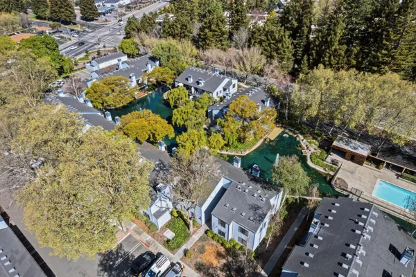 an aerial view of a house with a yard
