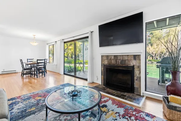 a living room with furniture a flat screen tv and a fireplace