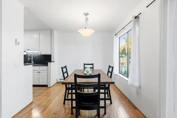 a view of a dining room with furniture and wooden floor