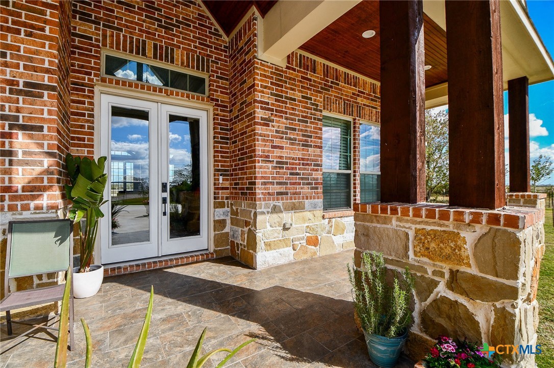 1093 Sunderman Road Alleyton, TX 78935 - Photo 16 of 48 a view of a balcony with chairs and a potted plant