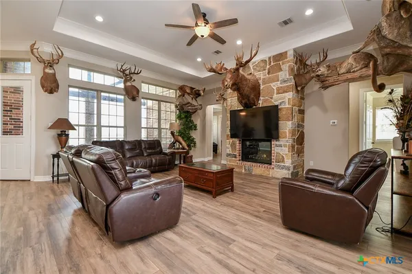 a living room with furniture wooden floor and ceiling fan
