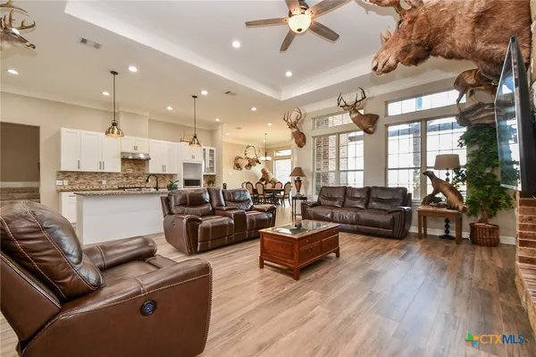 a living room with lots of furniture and kitchen view