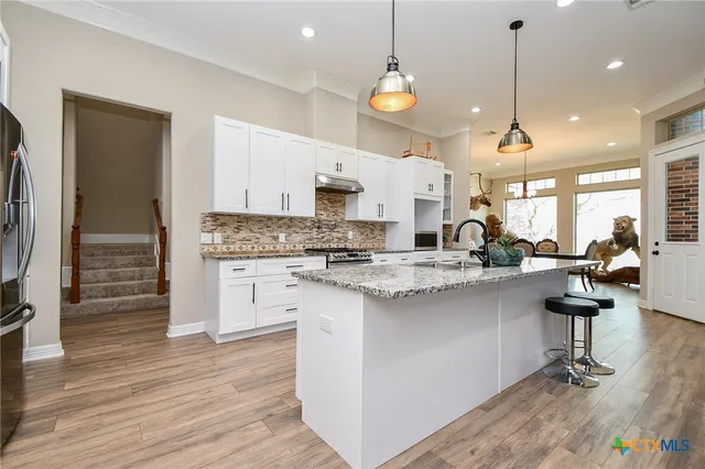 a kitchen with counter top space cabinets and a sink