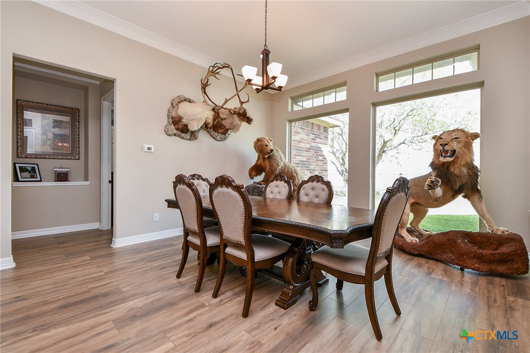 1093 Sunderman Road Alleyton, TX 78935 - Photo 26 of 48 a view of a dining room with furniture wooden floor and chandelier