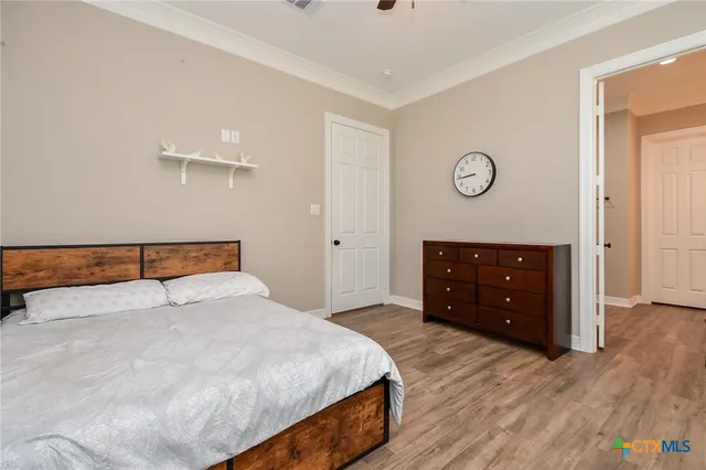 a bedroom with a bed and a dresser