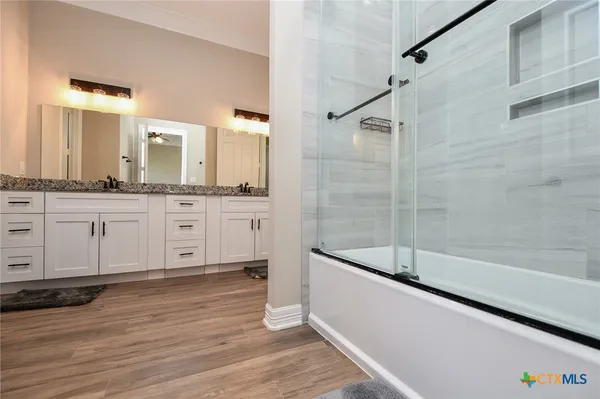 a bathroom with a bathtub and a sink
