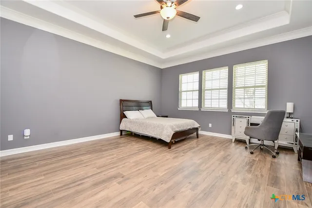 a bedroom with a bed and a desk