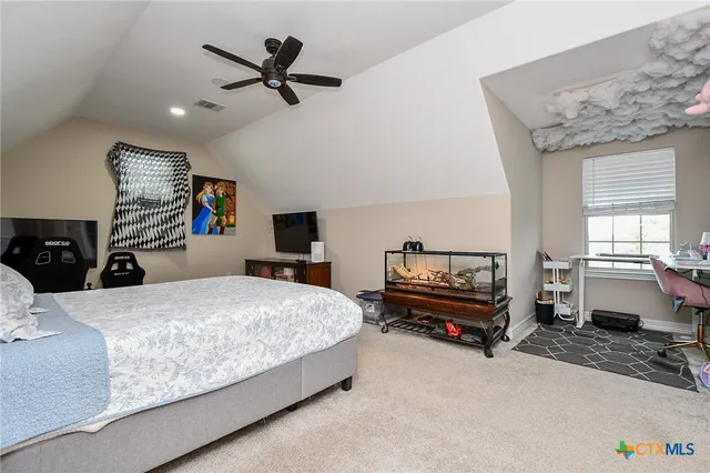 a bedroom with bed and a chandelier