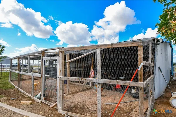 a view of a fountain in front of a house with a yard