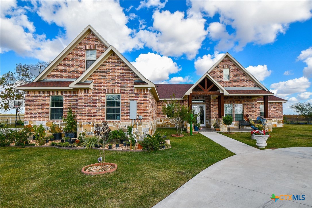 1093 Sunderman Road Alleyton, TX 78935 - Photo 6 of 48 a front view of a house with garden