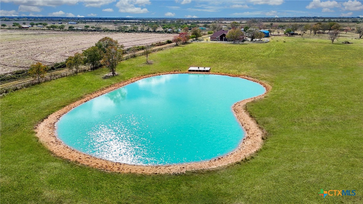 1093 Sunderman Road Alleyton, TX 78935 - Photo 7 of 48 an aerial view of a swimming pool with a yard and ocean view