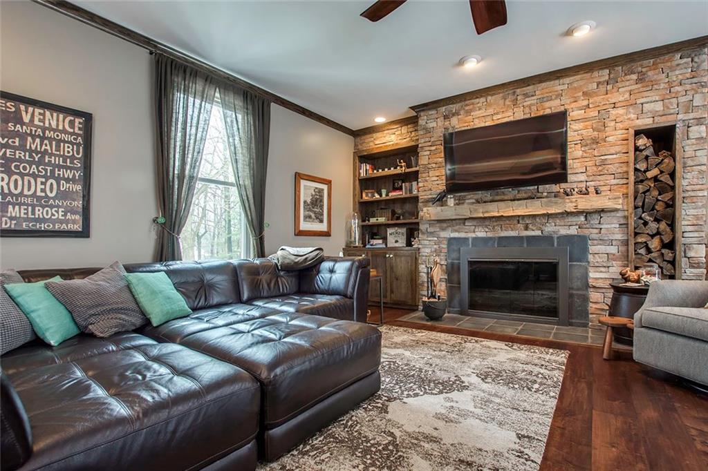 149 Backbone Road Sewickley, PA 15143 - Photo 13 of 25 Other Side of the Family Room with Stacked Stone Fireplace Surround, Built-In Bookcase and Built-In Wood Storage Area. Perfect Spot to Watch the Big Game!