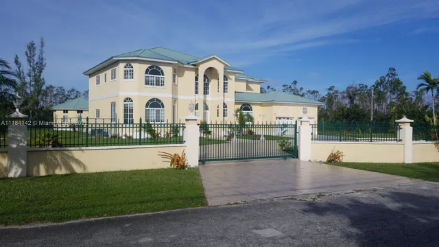 a front view of a house with a yard table and seating