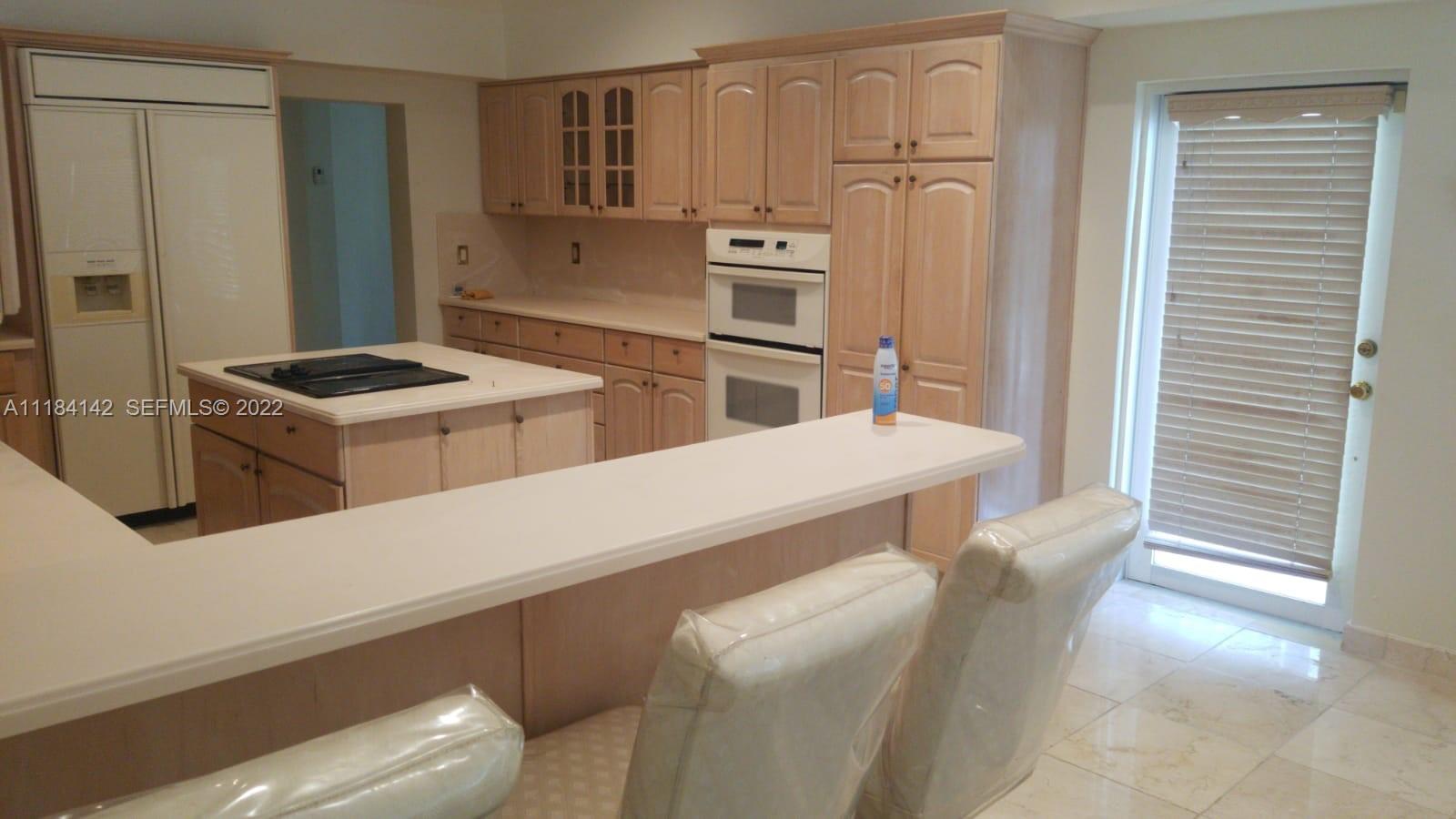 6 Bahama undefined, BA 00000 - Photo 4 of 15 a kitchen with stainless steel appliances granite countertop a refrigerator and a stove