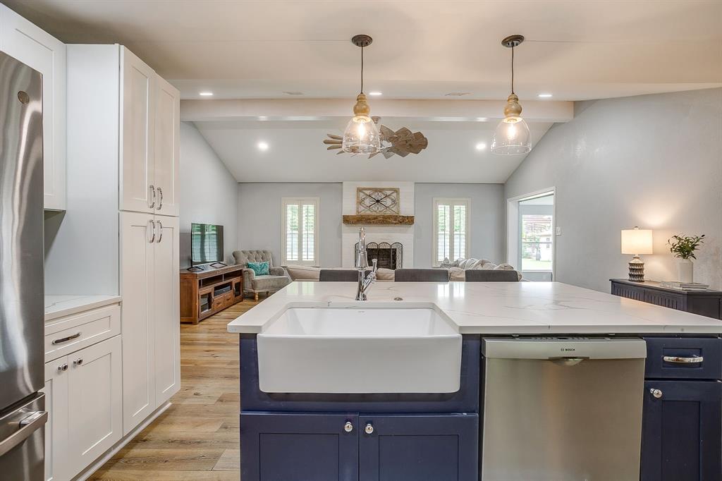408 Jeri Ridge Road Willow Park, TX 76087 - Photo 14 of 38 Kitchen island featuring a farmhouse sink, integrated dishwasher, and pendant lighting
