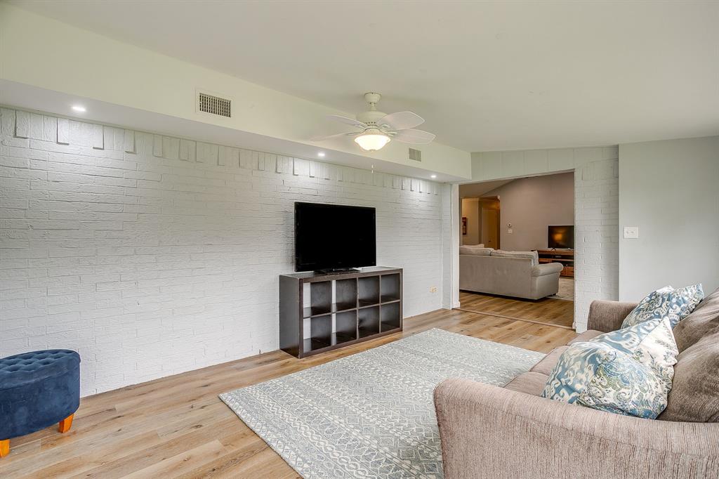 408 Jeri Ridge Road Willow Park, TX 76087 - Photo 19 of 38 Spacious living area featuring light wood-finish flooring, a textured white brick wall, and recessed lighting