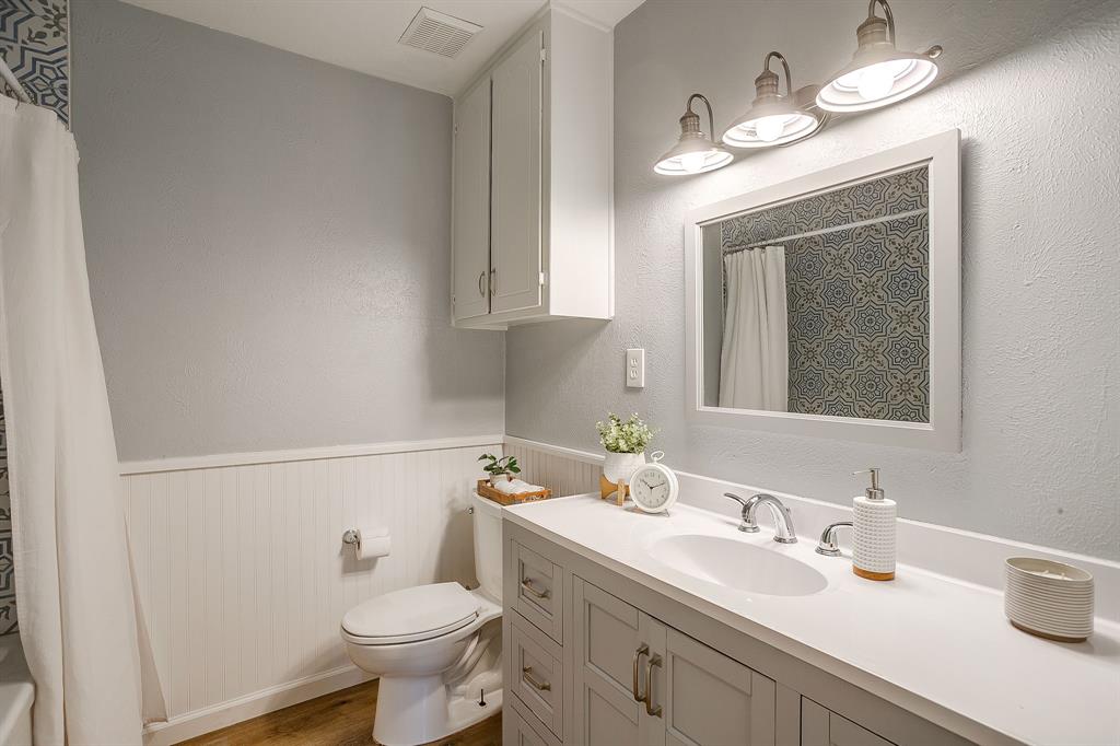 408 Jeri Ridge Road Willow Park, TX 76087 - Photo 25 of 38 Bathroom featuring a single vanity with an undermount sink, a framed mirror, and chrome fixtures