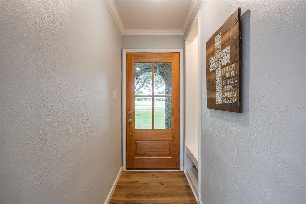 408 Jeri Ridge Road Willow Park, TX 76087 - Photo 3 of 38 Entryway featuring a wood-panel door with multiple glass panes, wood-finish flooring, and crown molding