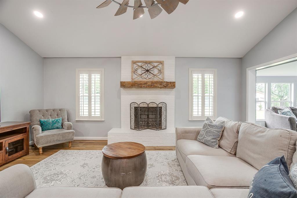 408 Jeri Ridge Road Willow Park, TX 76087 - Photo 4 of 38 Living area featuring a white brick fireplace with a wood mantel, wood-finish flooring, recessed lighting, and white plantation shutters