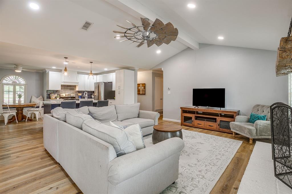 408 Jeri Ridge Road Willow Park, TX 76087 - Photo 6 of 38 Spacious living area featuring vaulted ceilings, wood-finish flooring, recessed lighting, a modern ceiling fan, and an open-concept design to the kitchen