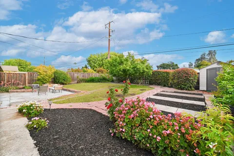 a front view of a house with a garden and plants