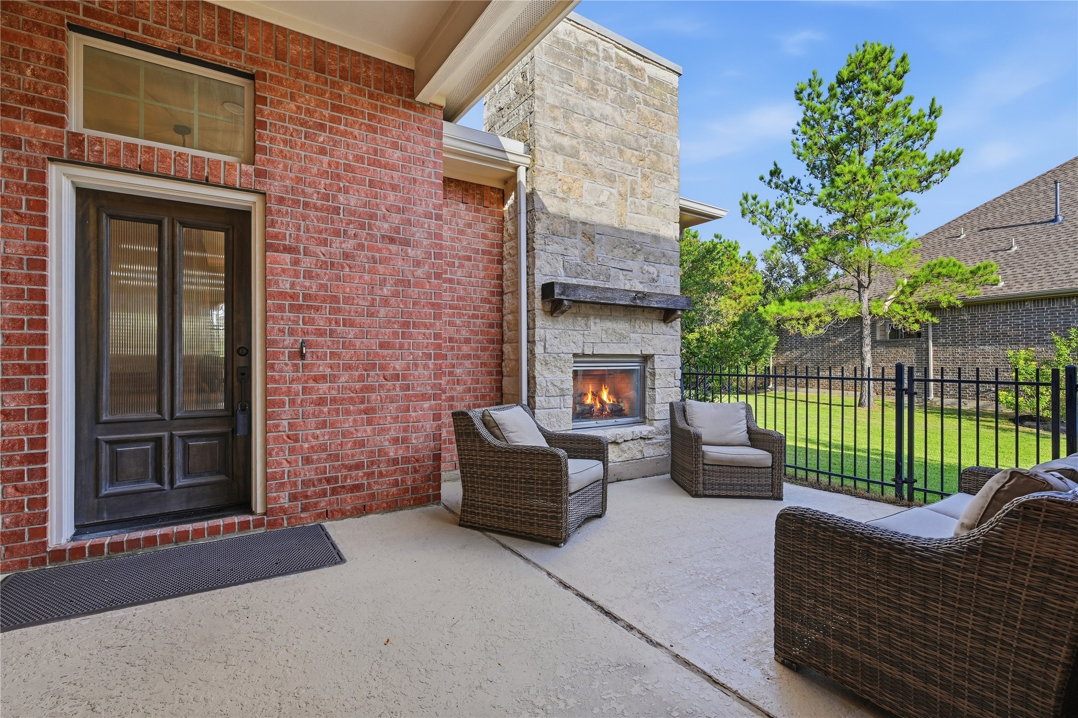 7 Sleeping Colt Place Spring, TX 77389 - Photo 2 of 32 Private courtyard with outdoor living space and gas-log fireplace