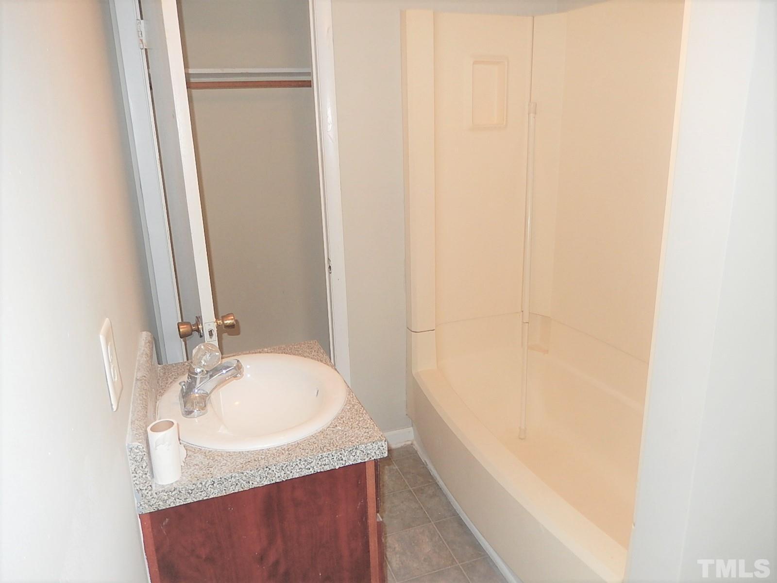 1015 Oberlin Road Raleigh, NC 27607 - Photo 17 of 26 a bathroom with a sink and a mirror