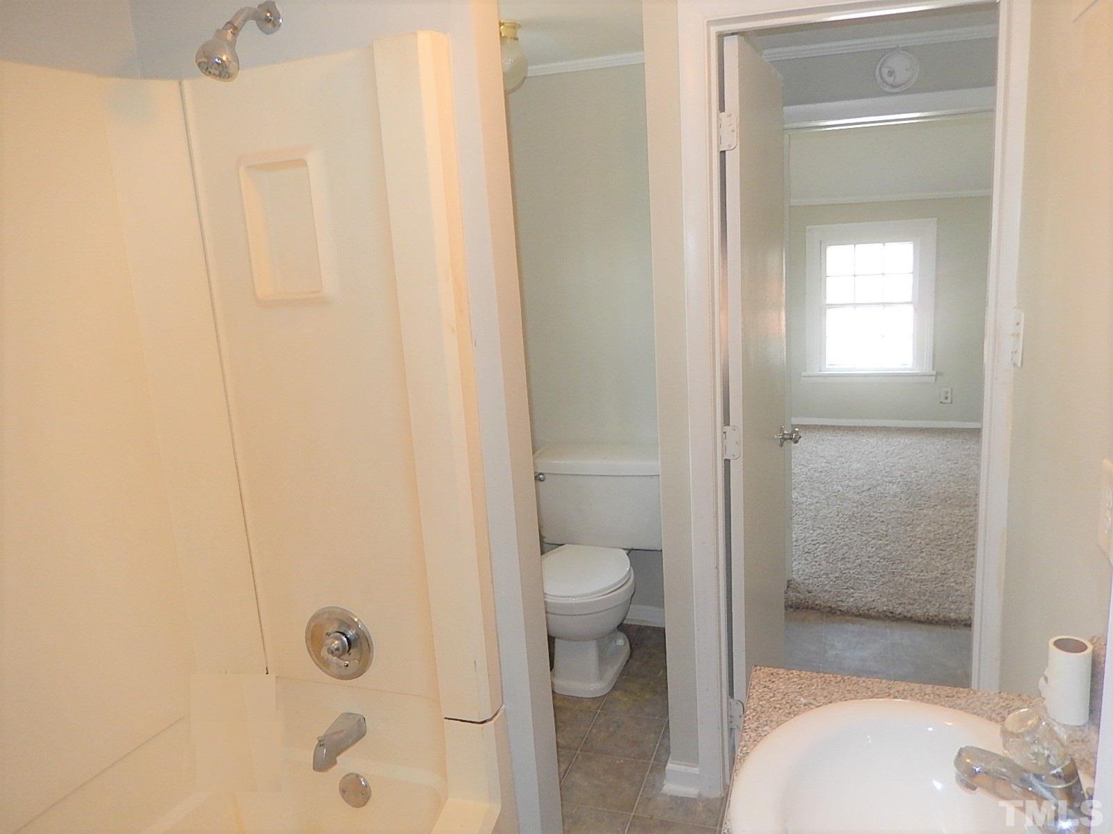 1015 Oberlin Road Raleigh, NC 27607 - Photo 18 of 26 a bathroom with a toilet and a shower