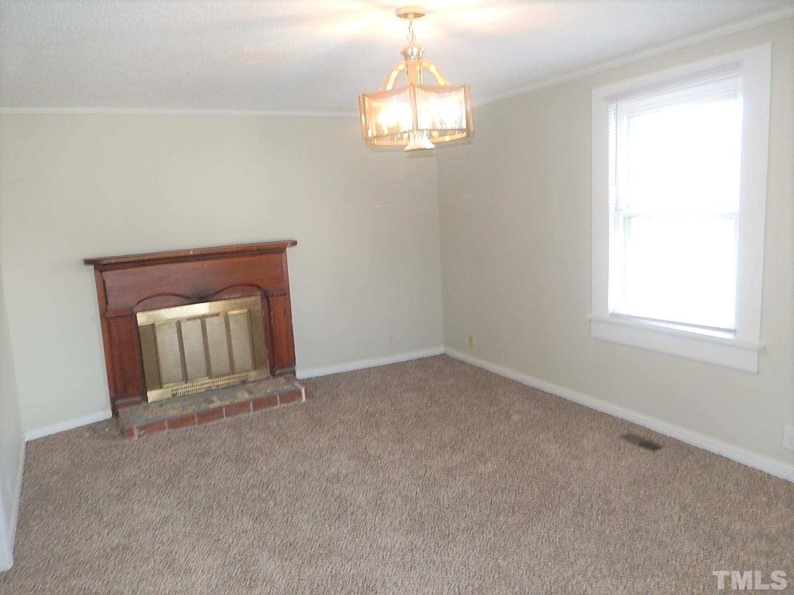 1015 Oberlin Road Raleigh, NC 27607 - Photo 2 of 26 an empty room with windows and chandelier fan