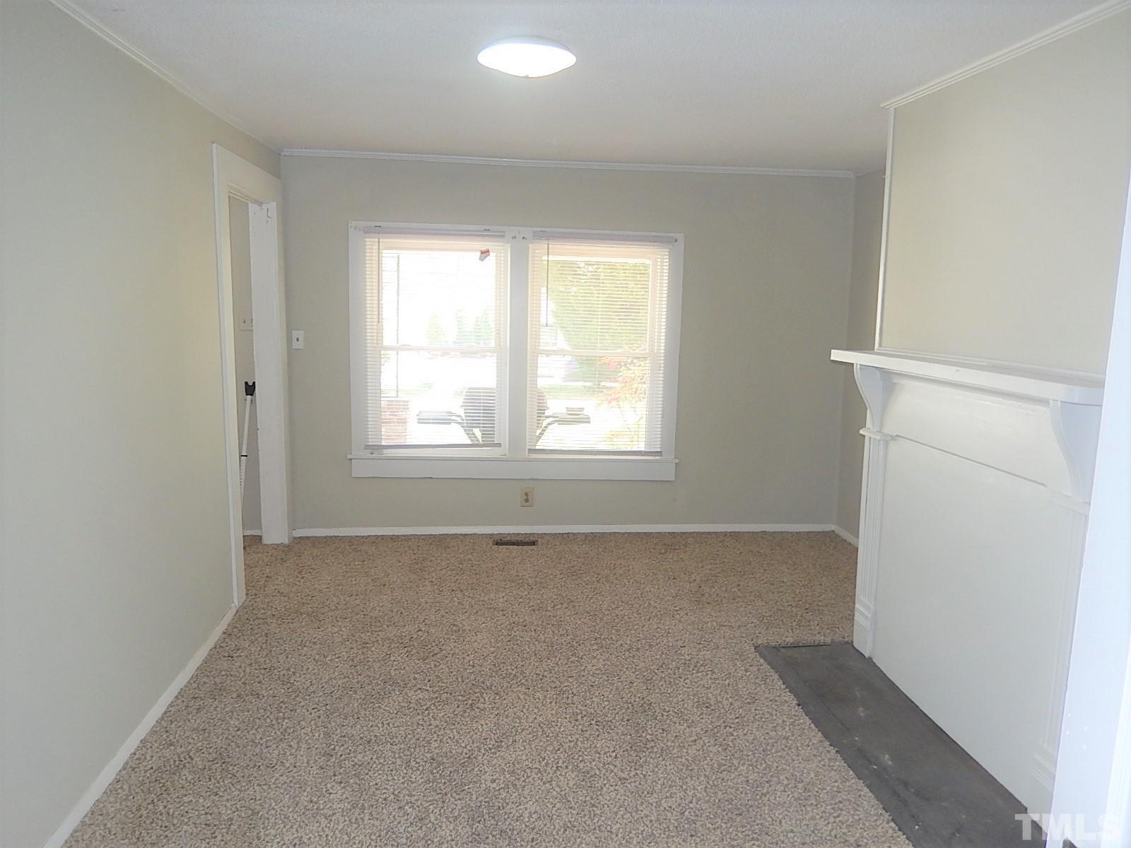 1015 Oberlin Road Raleigh, NC 27607 - Photo 4 of 26 a view of an empty room with a window