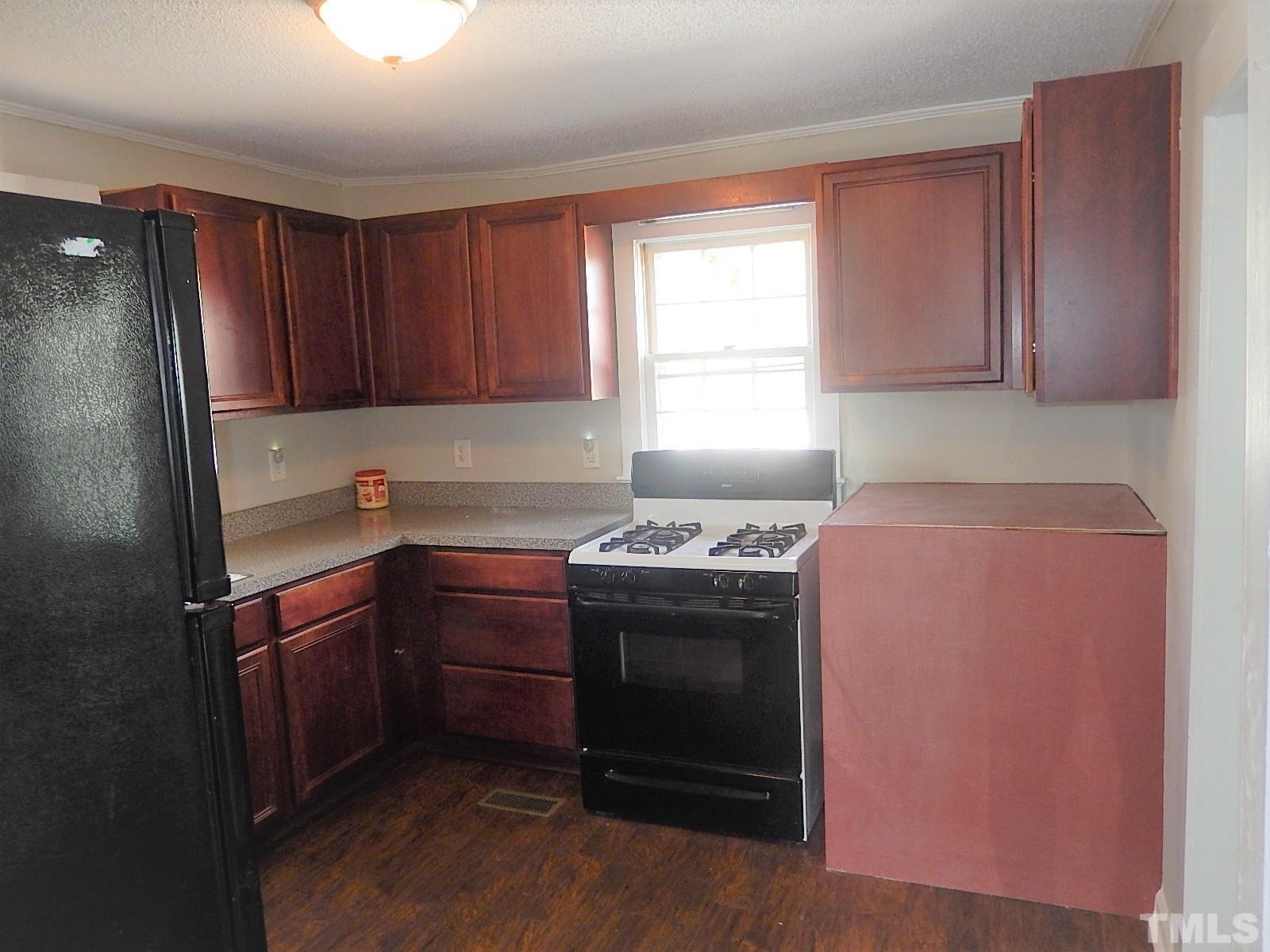 1015 Oberlin Road Raleigh, NC 27607 - Photo 5 of 26 a kitchen with granite countertop a sink stove and cabinets