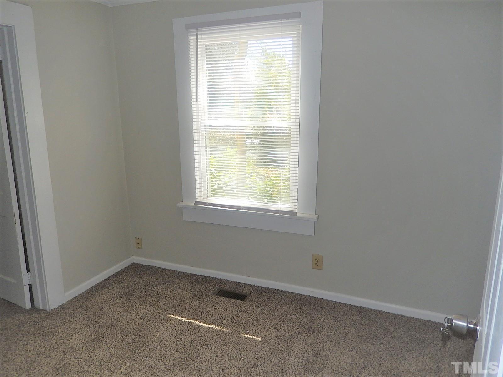 1015 Oberlin Road Raleigh, NC 27607 - Photo 9 of 26 an empty room with a window