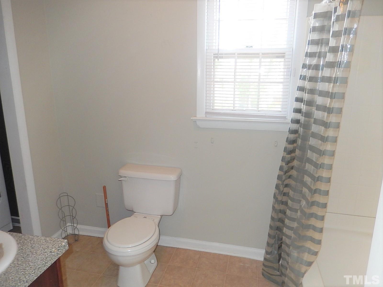 1015 Oberlin Road Raleigh, NC 27607 - Photo 10 of 26 a white toilet sitting next to a window