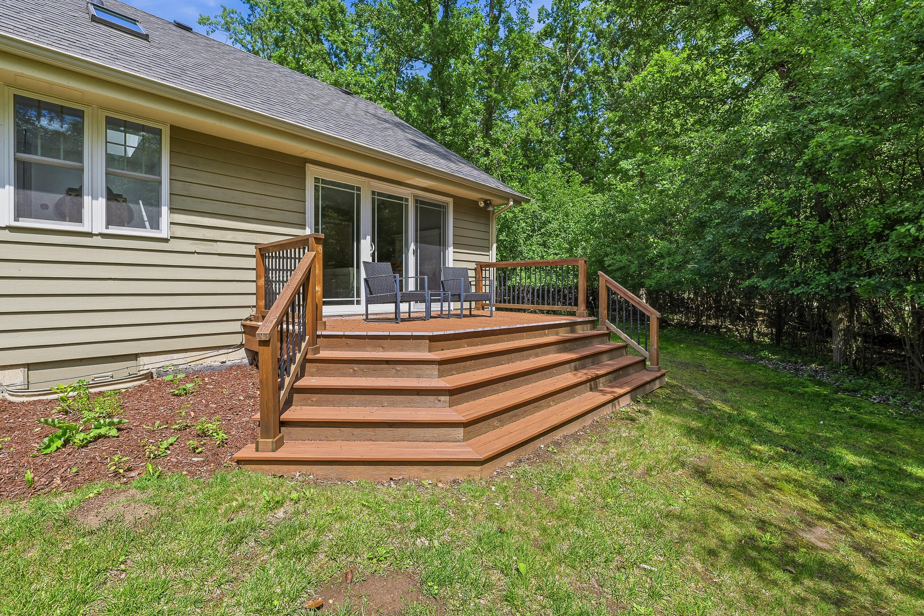 34899 Pabst Road Summit, WI 53066 - Photo 14 of 38 Private deck off the primary suite—perfect for morning coffee and watching the wildlife wander by.