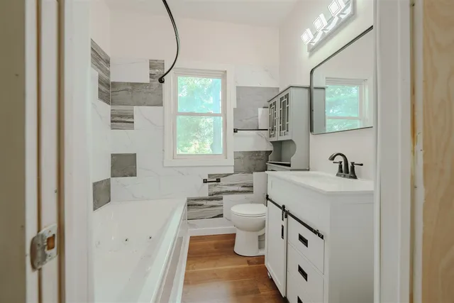 a bathroom with a sink a toilet and a mirror