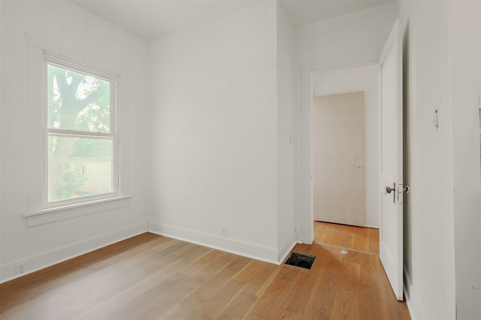 804 North Walnut Street Pontiac, IL 61764 - Photo 19 of 38 an empty room with wooden floor and windows