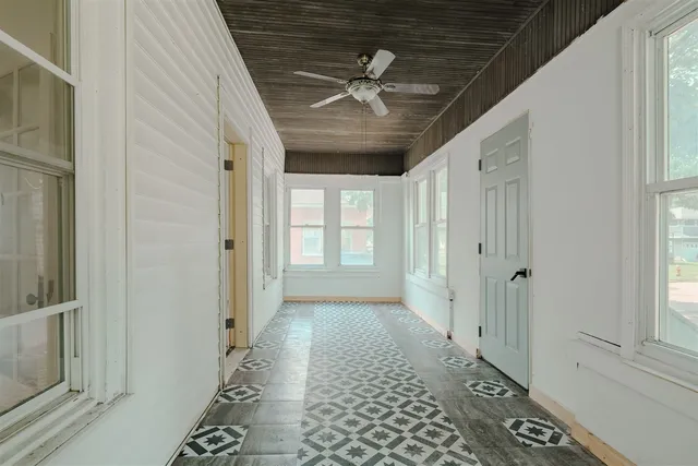 a view of hallway with a window and stairs